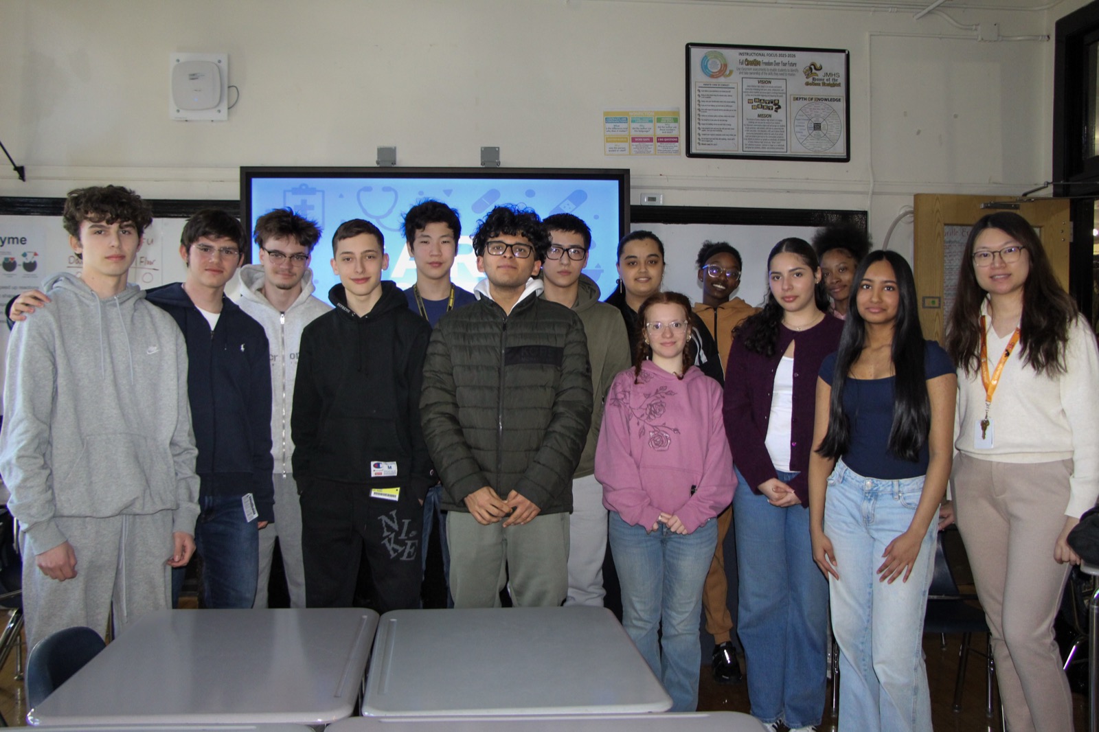 The CARE student team standing together in a classroom